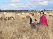 Cherie Pagan and her son in the paddock with some of their stud Border Leicester ewes. Photo: supplied