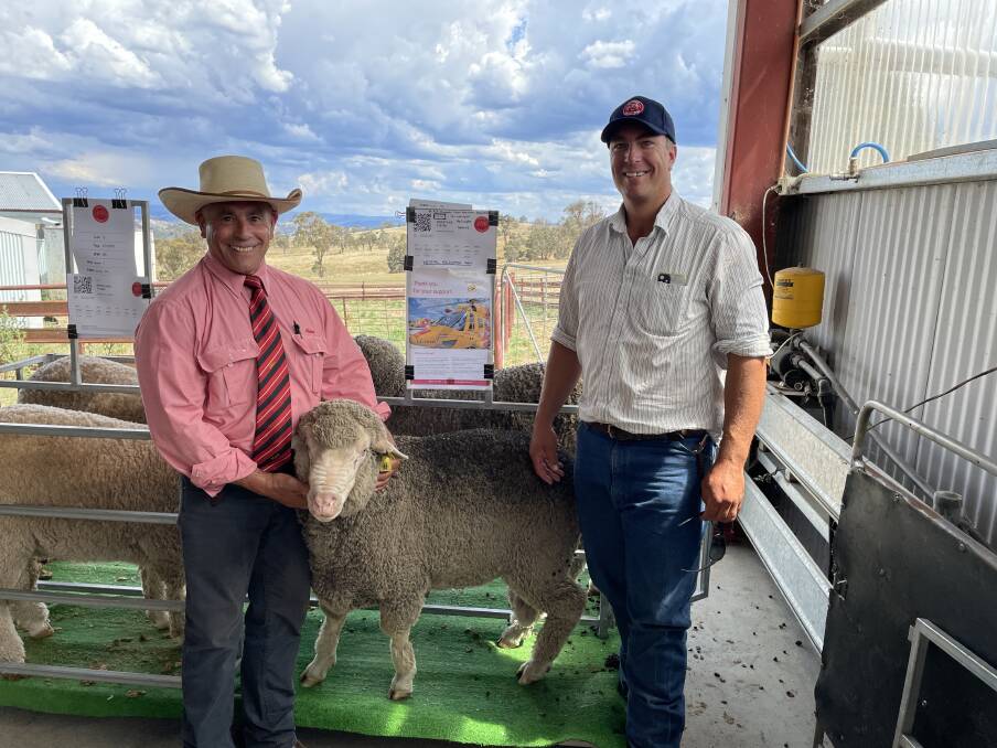 Elders Walcha branch manager Tom Henry with Angus Laurie, Deloraine Walcha and the $2500 ram, whose proceeds will be donated to the Westpac Rescue Helicopter Service.