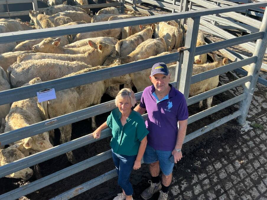Jeff and Janice Jones with their pen of 223kg Charolais heifers, which made 360.2 c/kg.