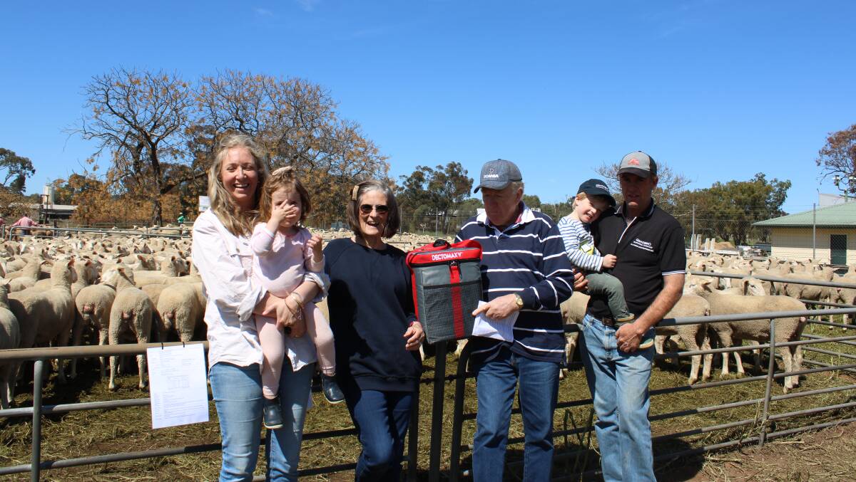 The Bruckner family, Gnadbro Pastoral Company, Collingullie with some of the 350 ewes that made the top price of $390. Pictured is Emma, holding her daughter Alice, Zandra and John with Heath Bruckner and his son John. Photo supplied
