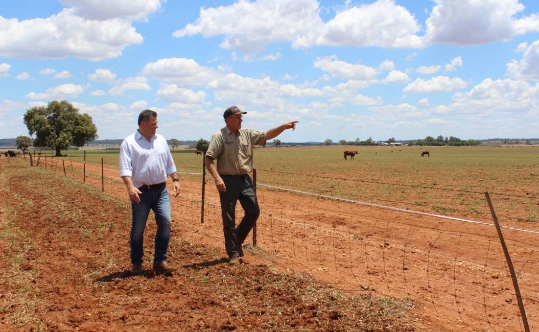 Member for Orange, Phil Donato, discusses fencing with Parkes district farmer Wayne Dunford. Picture supplied