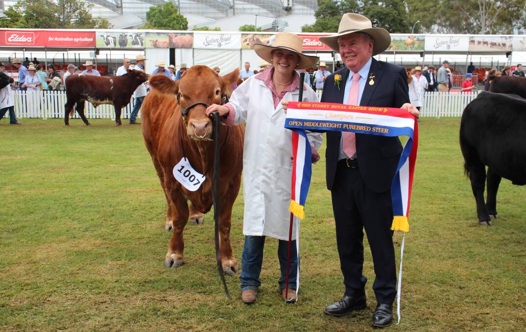 Hannah Gill, Scots All Saints College, Bathurst, and RAS president Michael Milner, with the champion middleweight steer. Photo by Alexandra Bernard