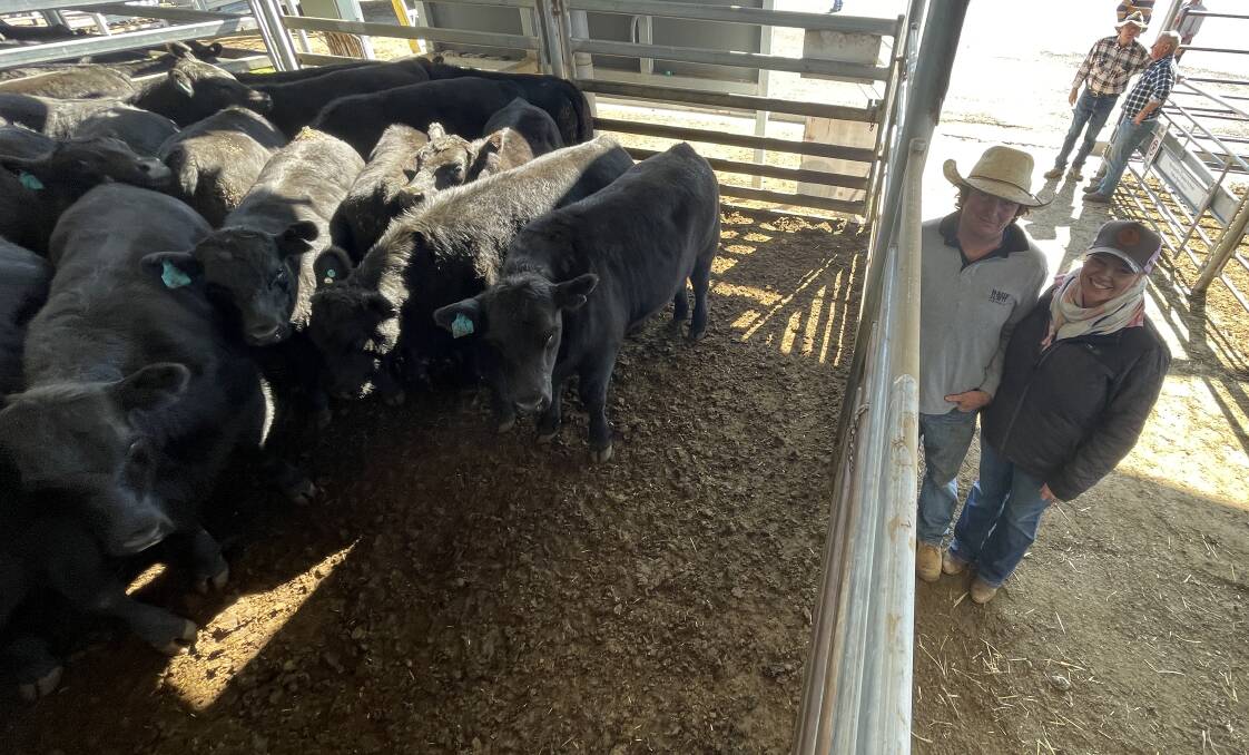 Thomas and Katie Jayne O'Brien, Braidwood, with their pen of 24 Angus steers, 411kg, which sold for $1440 a head and were the best presented pen of steers at Yass on Friday. Picture by Alexandra Bernard. 