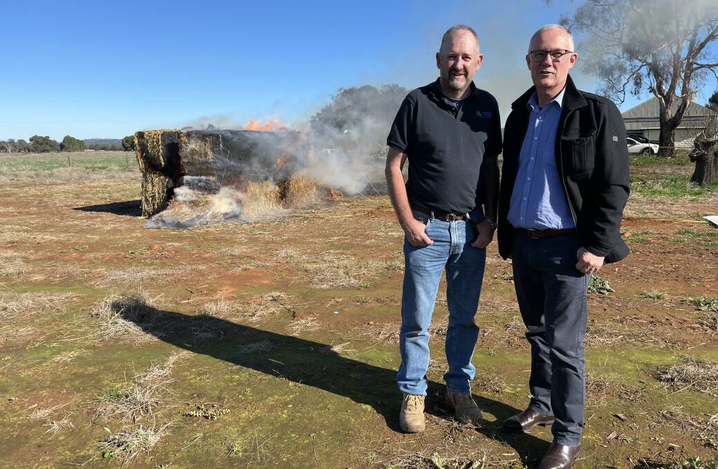 Charles Sturt University lead researcher Dr John Broster, Wagga Wagga, and Paul Sheridan, Myriota, with a test haystack to measure temperature changes and conditions in a haystack fire. 