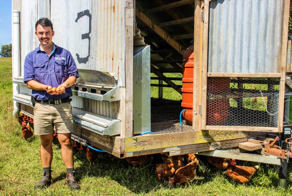 Jake Wolki with one of his portable chicken houses. 