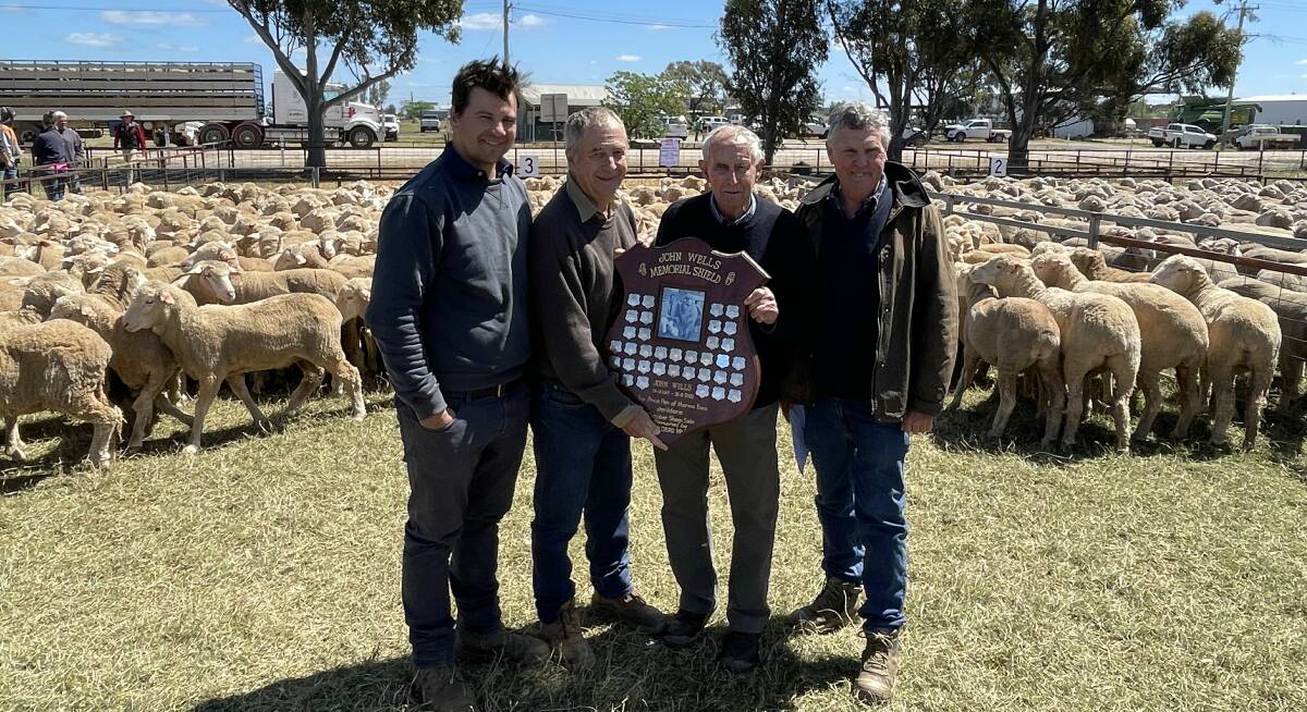 Joint winners of the John Wells Memorial Trophy for top-priced pen Will and Don Bull, Irroy, Conargo and Ross Wells, Willandra, Jerilderie, with classer Chris Bowman. Photo by Alexandra Bernard.