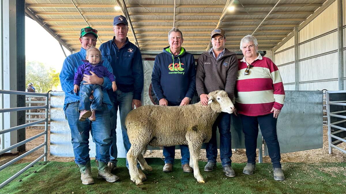 Jess Patterson and Gracelynn Southwell, Rowallan stud principal Matt Reid, Crowther, Graham Southwell, Rye Park, Butt Livestock and Property agent Isaac Mannion, Yass and Euphemia Southwell, Rye Park, with the ram that sold for $4000. Picture by Elka Devney 