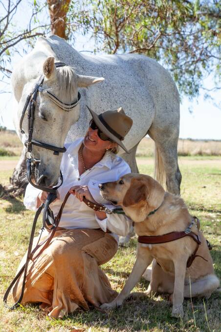 Sue-Ellen Lovett, with horse Blue and guide dog Woody, Abaquil, Dubbo. Picture supplied.
