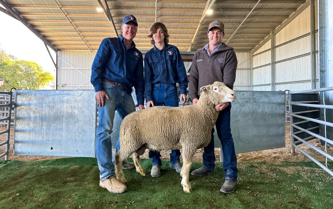 Rowallan stud principal Matt Reid, Nate Reid, Crowther and Butt Livestock and Property agent Isaac Mannion, Yass, with the top priced ram which sold for $4400. Picture by Elka Devney