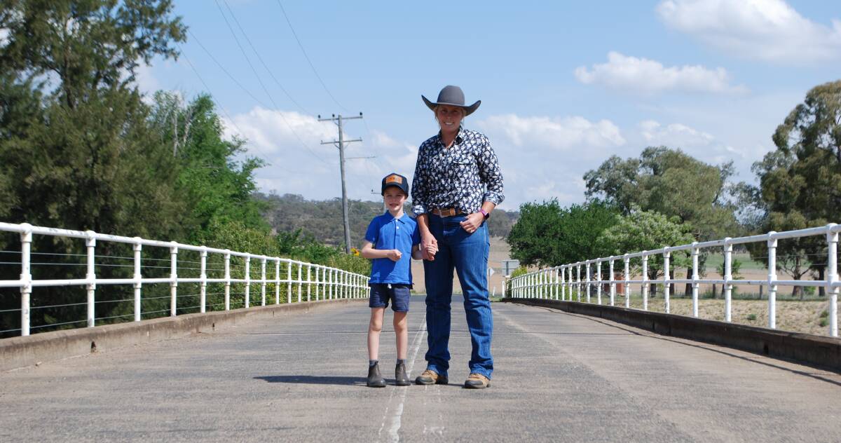 Cassilis resident, Shelley Piper, and her son, Owen, 6, on the bridge into the village, which has no pedestrian lane but will form the main traffic route during the project construction phase. Picture by Rebecca Nadge.