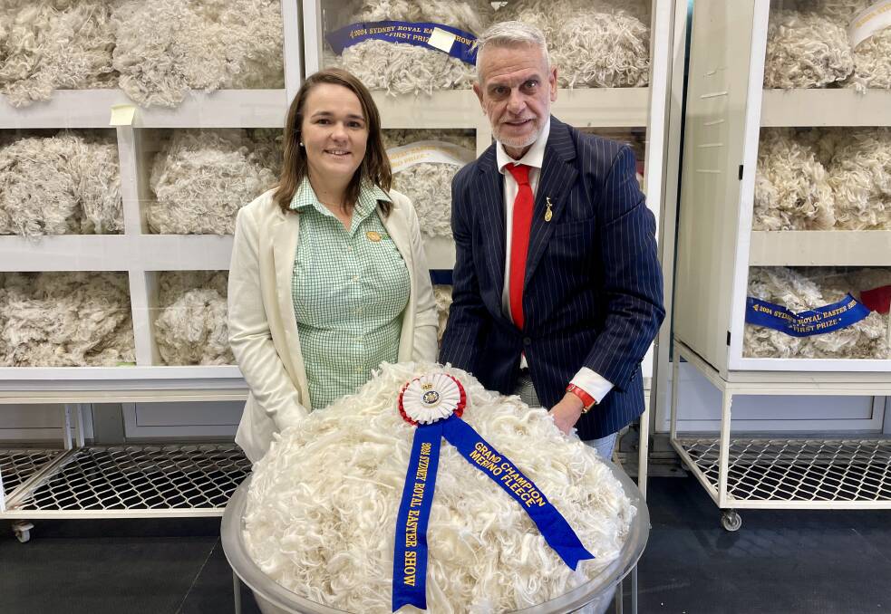 Steward Heather Earney, Trundle, and chief steward Greg Andrews with the grand champion fleece. Picture by Rebecca Nadge.