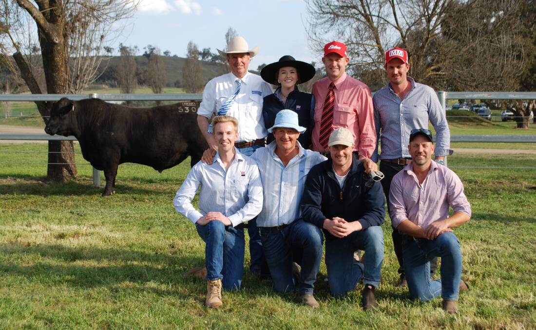 Auctioneer Paul Dooley, Annie Pumpa, ABS Australia, Andrew Bickford, Elders, Trent Walker, with (front) Fletch Kelly, ABS Australia, Ross Thompson, Millah Murrah, Will Couch, Couch Pastoral, and Rob Swinton with the top-priced bull.