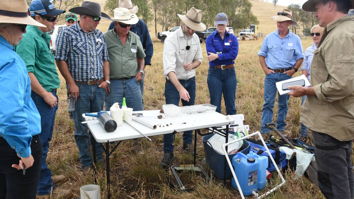 Mr Diark showing field day attendees how to perform an aggregate stability test on a soil sample. Photo by Helen De Costa. 