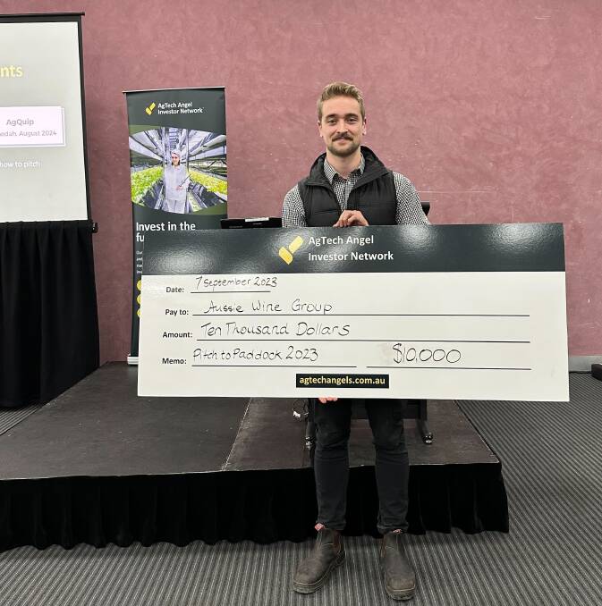 Zac Villis, from the Aussie Wine Group, with the company's $10,000 cheque from this year's AgSmart event. Picture file