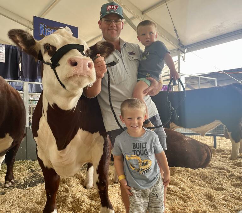 Kierin Martin with his sons, Blair, 4, and Riley, 2, with one of his Poll Hereford heifers.