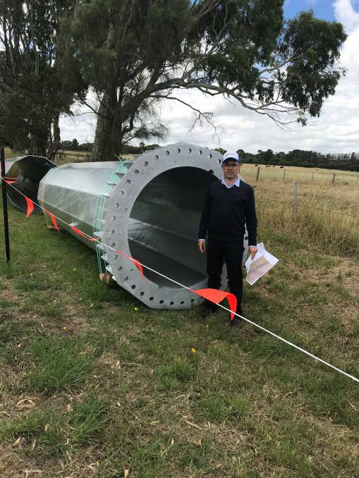 Member for Polwarth Richard Riordan with one of the pylons that support the transmission line from the Salt Creek wind farm to Terang.