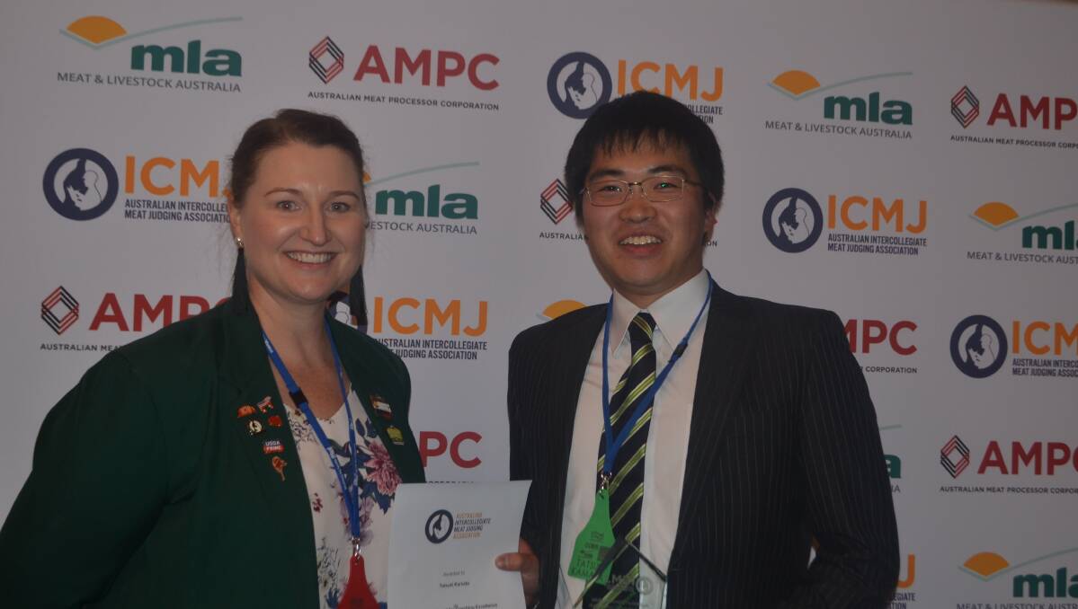 Demi Lollbach, ICMJ committee presenting Tom Carr Award for coaching excellence to Tatsuki Kamata, coach Japanese National Team
