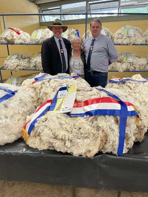 RNCAS councillor Ben Litchfield, steward Broni Jekyll, and chief steward Stuart Sutherland, with the grand champion fleece at the Canberra Show.