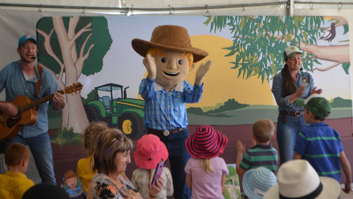 Ben Hood, George the farmer and Simone Kain entertaining children during the HMFD with an agricutural version of The Wiggles.