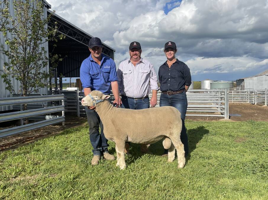Dane Rowley with Kyle and Lisa Sturgess, Redline stud, West Wyalong, with the second top priced ram.