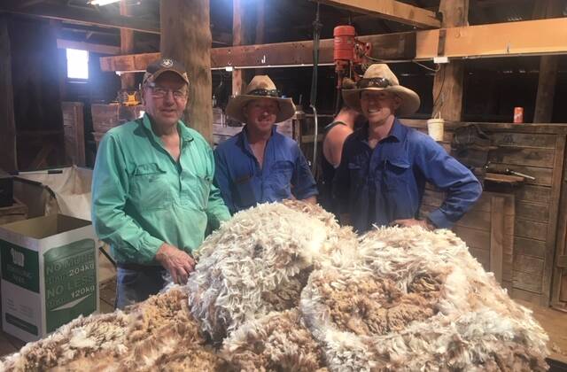 Doug, Glenn and Brad Hart classing Merino fleeces in the Naradhan woolshed. Photo: Anna Hart