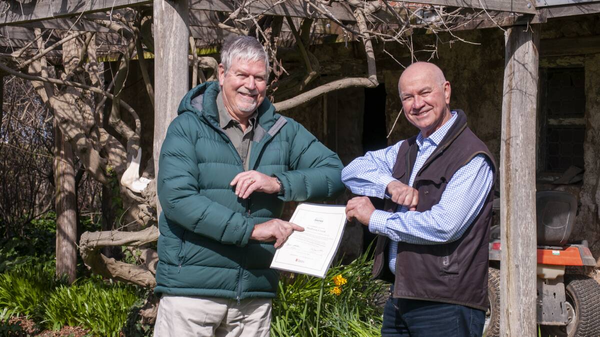 COVID-19 style congratulations: Tony Hill (Land to Market Australia) awarding the Ecological Outcome Verification certificate to Gary Nairn AO (The Mulloon Institute). Photo: The Mulloon Institute
