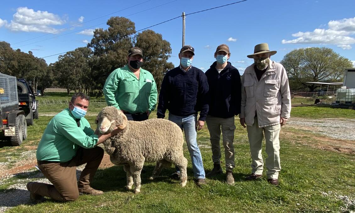 Tim Woodham and Toby Elliott, Nutrien Livestock, with buyers Michael and Paddy Lowe, Crookwell, and Royalla co-principal Winston McDonald with the top priced ram. Photo: Tim Woodham

