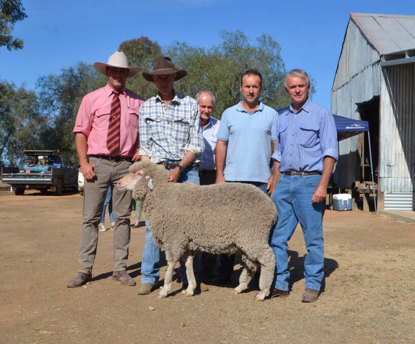 Elders Young auctioneer Aaron Seaman and co-vendor Trevor Ryan with James, Neil and Andrew Lawson, and the top priced ram purchased by the Lawson family from Cookardinia.

