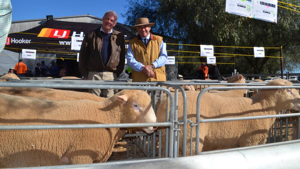 TOP GROMARK: With the top priced ram purchased for return clients, Byrne Pastoral Co, Wallendbeen are Neville Manglesdorf and Joe Bargwanna, guest auctioneer.