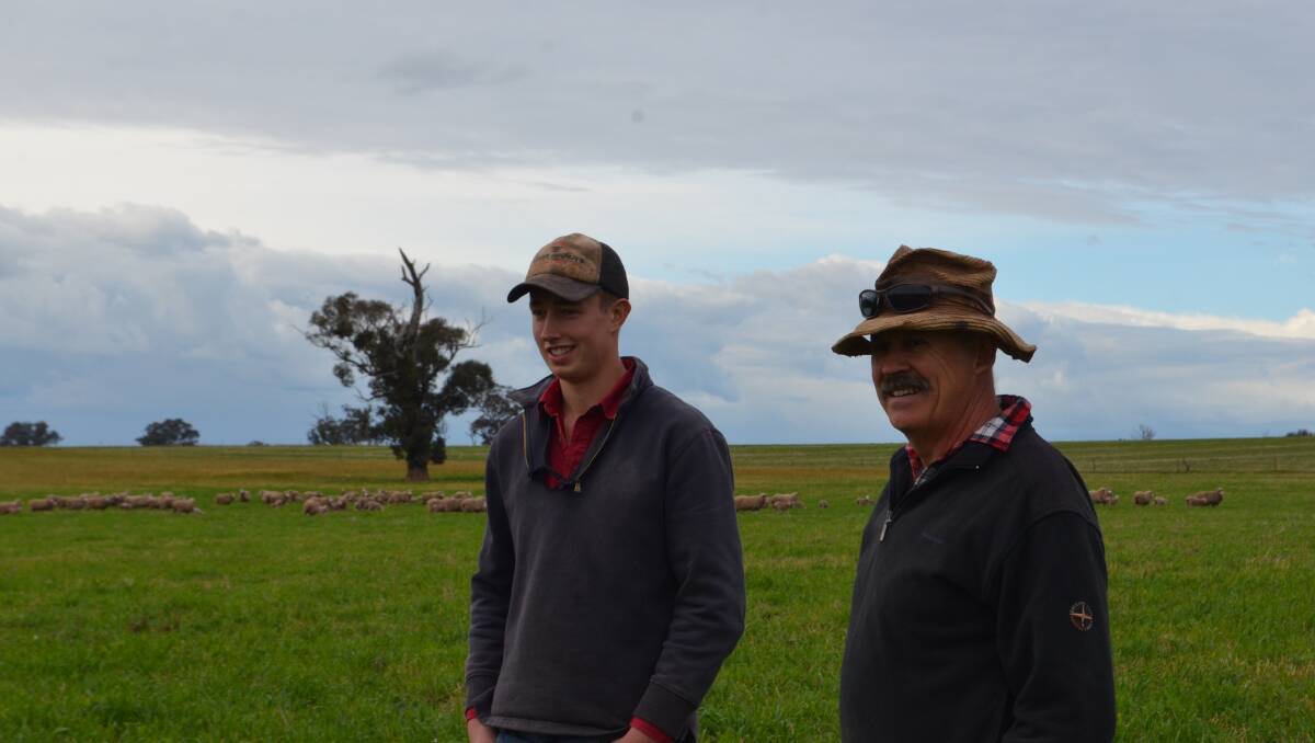 Archie Alexander with his father Brent in the paddock of mixed species cover crops grazed by September-shorn Merino ewes with July-drop lambs.
