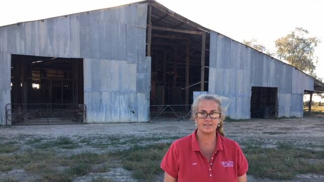 Kim Chandler in front of the woolshed to be restored on Dunlop Station, Louth. Photo: Kim Chandler
