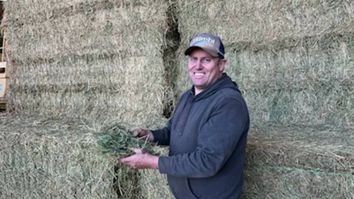 Anthony Smith is all smiles with a sample of the winning best looking Lucerne hay he and his family grew at Bedgerabong. Photo: Melissa Smith
