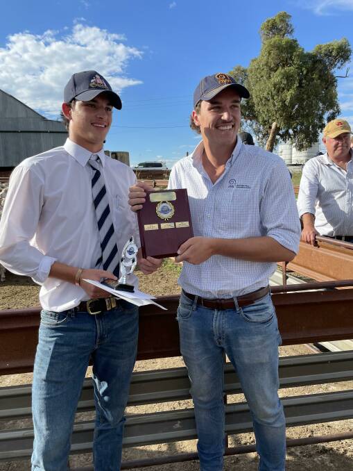 Archie Dowling, St Stanislaus College, Bathurst, winner of the 2022 Junior Judging conducted during the 2022 Southern Tablelands Flock Ewe Championship, congratulated by George Lehmann, representing sponsor Australian Wool Innovation. 