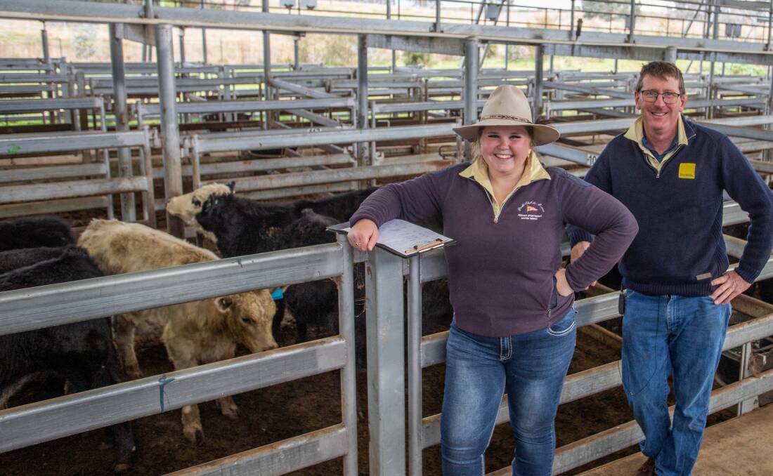 Clare Southwell and Paul Costigan, Ray White Livestock, Yass, with six Angus-cross steers weighing 233.3kg that sold for $1101 a head by the Wilson Family Trust, Gurrundah. 