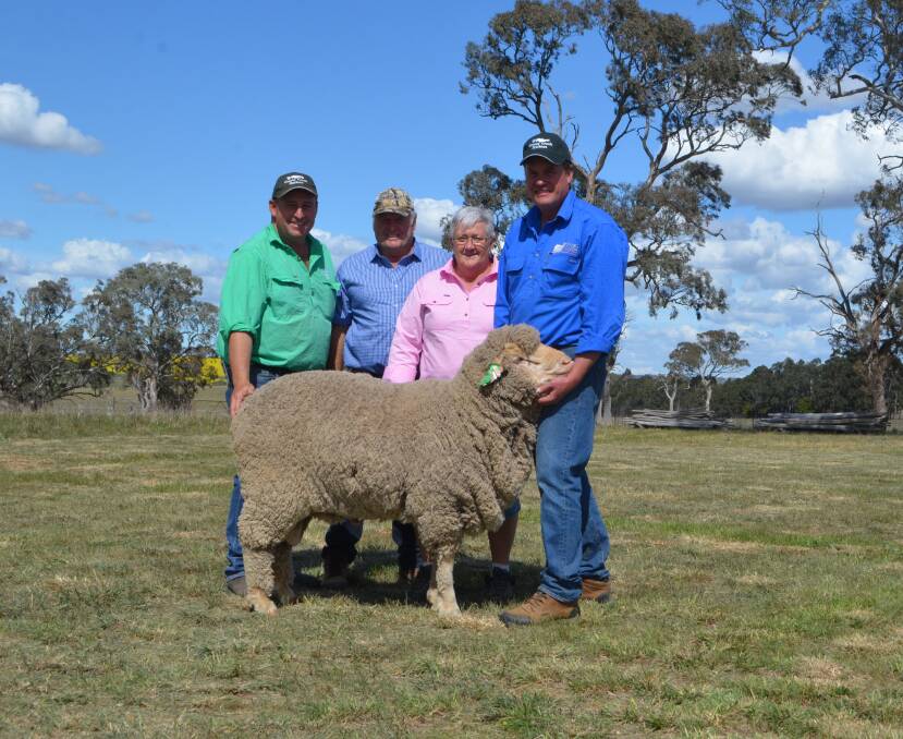 Michael Corkhill with Garry and Kaye Davidson, Walpa, Victoria and their purchase at $5750 paraded by sheep consultant, Craig Wilson.