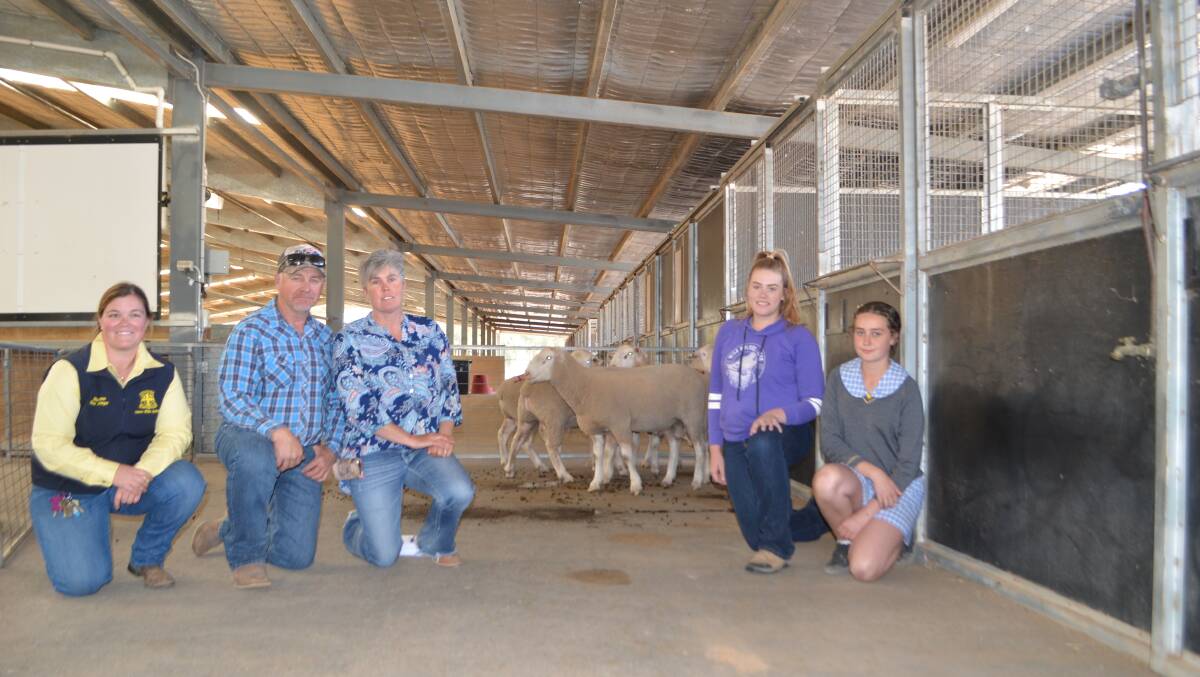 With their draft of seven rams including the top price: Ellie Quinn, Yanco Agricultural High School, stud manager and agriculture teacher, buyers Michael and Natalie Wilkinson, managers Stockinbingal Pastoral Co, Wallendbeen and their daughters, Montanna and Maci.