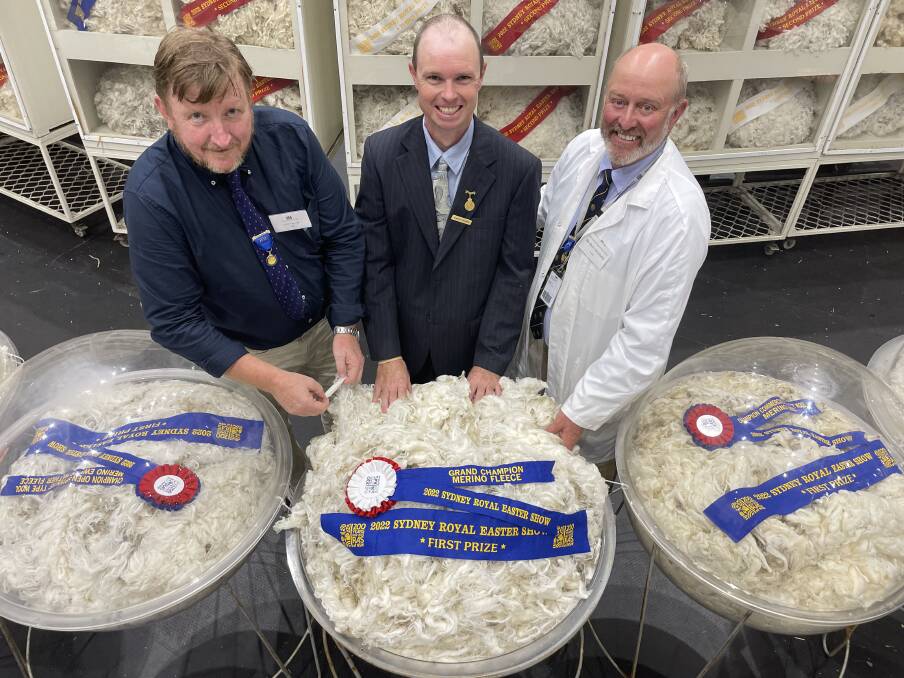With the grand champion fleece: judge Scott Carmody, wool buyer and exporter, RAS councillor and fleece steward Joe Byrne, and judge Ben Litchfield, SBBL Cooma.