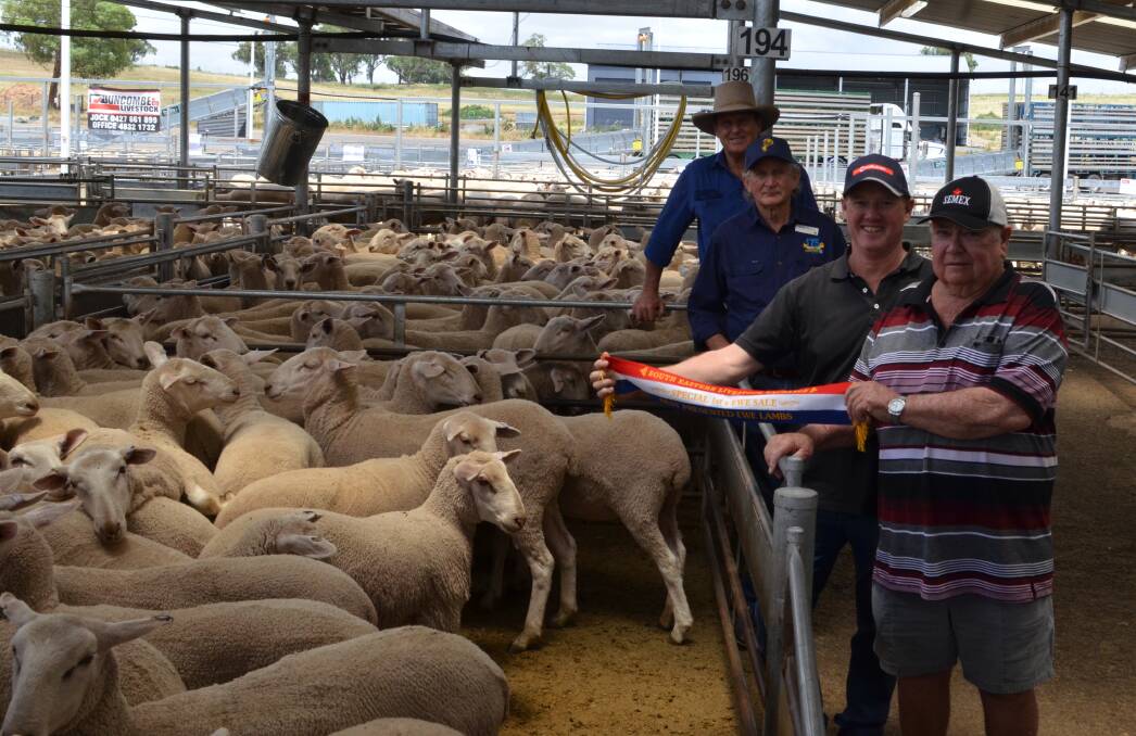 Right to left - with their pen of first-cross ewe lambs sold for $420, Keith and Glen Gordon, Donach Farms, Barellan displaying sash for best presented pen sponsored by George Hancock, Coopers Animal Health and SELX Yass saleyards manager Rick Maslin.