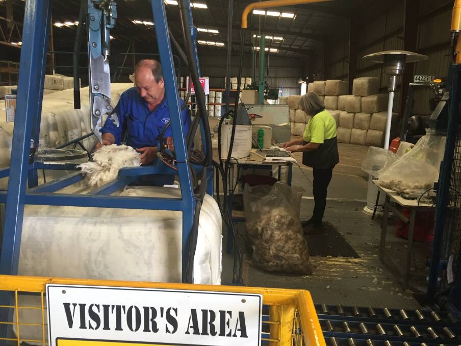 Gordon Litchfield Wool director Gordon Litchfield taking core samples from the bales of wool processed in the company's Cooma store.