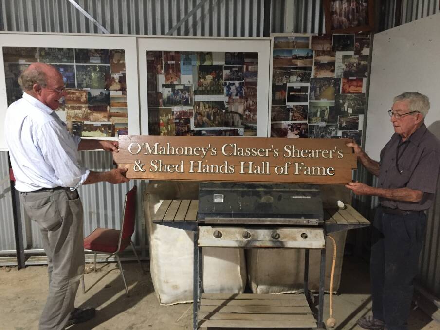 Richard Carter assisting Brian O'Mahoney with the banner in Brian's photo collection on display at the family farm.