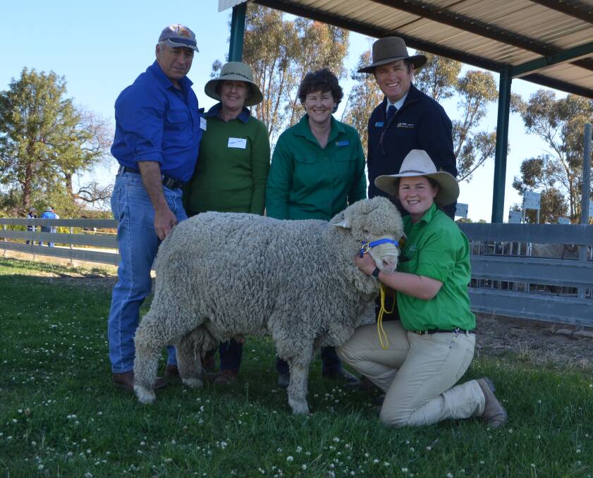 Graham and Debbie Mott with Amanda, Colin and Amelia McCrabb and the top priced Poll Merino ram at $5000. 