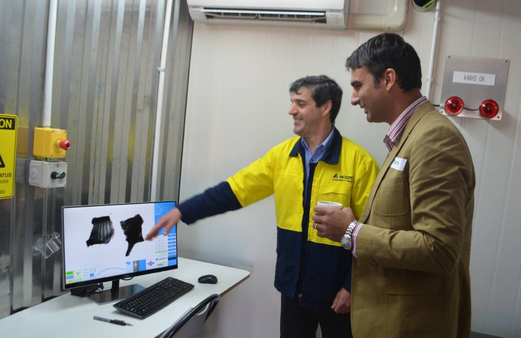 Paul Danelutti, Scott Automation and Robotics, Rydalmere and Dr Peter McGilchrist, Murdoch University, Perth, looking at the image of a beef carcase as assessed by the new DEXA system showcased at Jindalee Feedlot.
