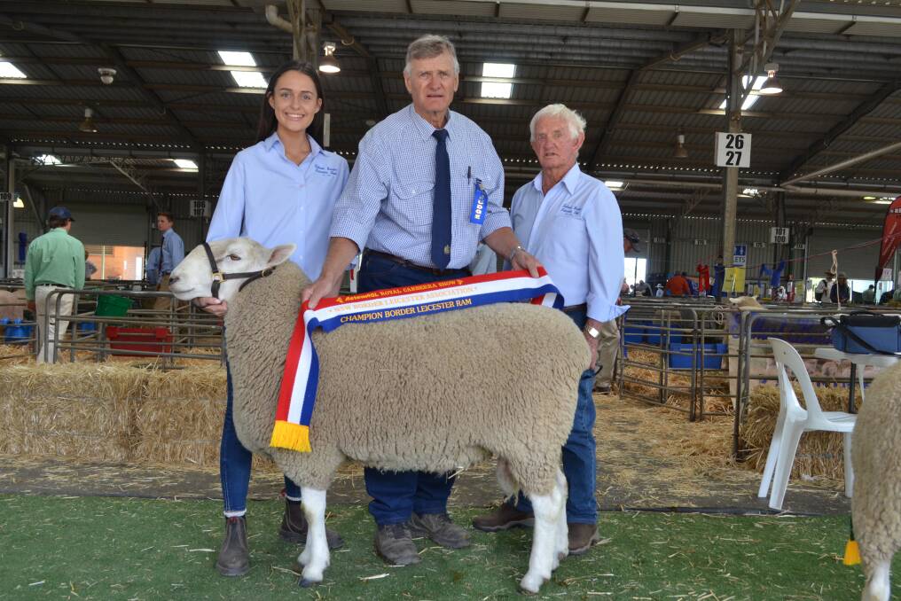 Judge Graeme Golder, Tegra, Temora sashes the champion Border Leicester ram paraded by Alexandra Branson while her grandfather Bob Anderson, Talkook Border Leicesters, Crookwell looks on proudly.