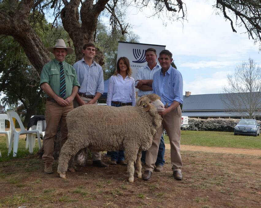 Rick Power, Landmark sheep consultant to Cottage Park, with Yarrawonga's Sam Phillips, buyers Jody and Mark Pendergast of Cottage Park, Cooma, and Steve Phillips, Yarrawonga, with the top priced ram worth $22,000.