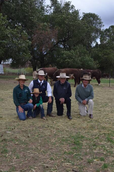 Nicki and Lily Pearce, auctioneer Michael Glasser and buyers of top priced bull, Geoff Coghill and David Meikle.