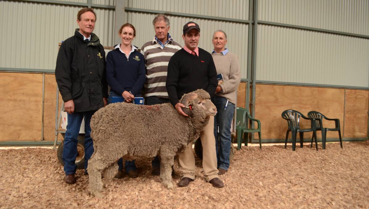Jim and Bea Litchfield, Hazeldean Merinos, Cooma, with the top priced ram bought by Bill and Sarah Brewis, Dalgety, and held by Sam Green, Elders, Cooma.
