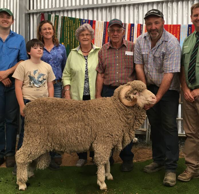 Vendors Jamie and Jayne Lette, with buyers Lorraine and Ron Veness, Rye Park, while Conrayn studmaster Pete Lette holds the top priced ram. Photo: Supplied