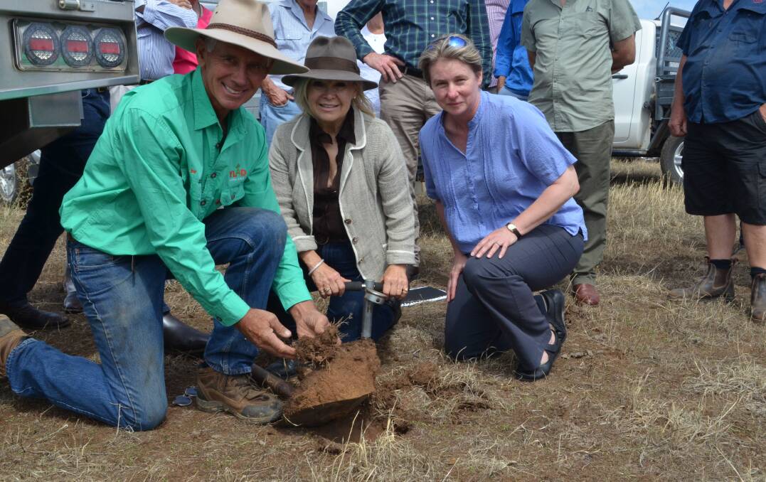 Looking at the healthy soil on their Young district property - Bill and Rhonda Daly examine a shovel full of viable soil with Dr Shane Powell, University of Tasmania, Hobart.