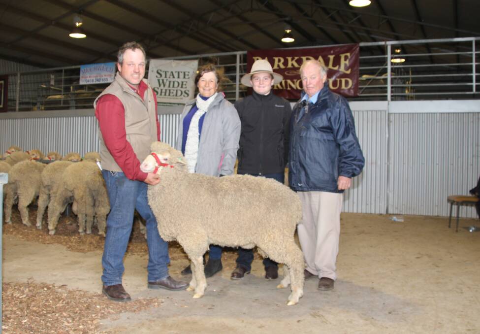 Robert Mudford, with long time purchasers Angela and Micheal Day with their grandson Riley with the second top priced ram who they purchased for $5200.
