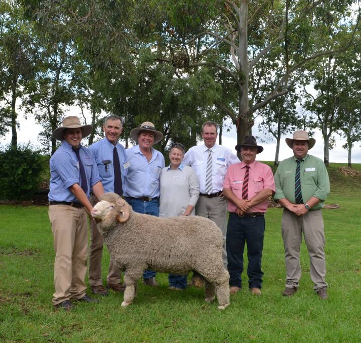 Egelabra Jackaroo Jack Kelly holding the $9000 ram purchased by Spike and Kirsty Wall and family with vendor Cam Munro, auctioneer Paul Dooley, Elders Livestock agent Scott Thrift, and Brad Wilson of Landmark Stud Stock.